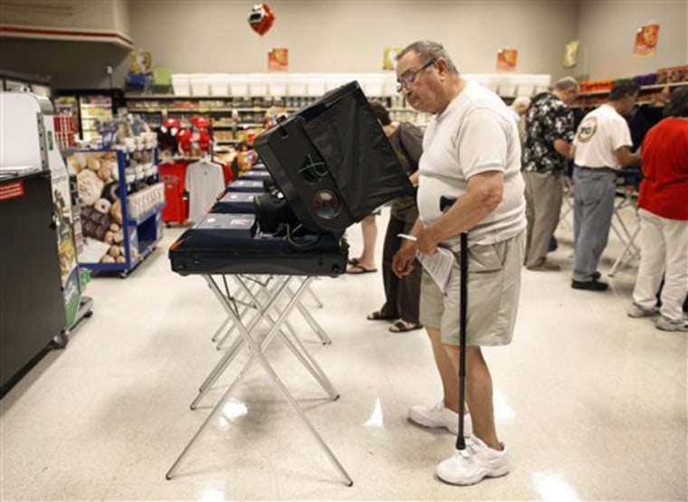 Ed Stolarczyk looks over the ballot at an early voting polling station at a grocery store in Las Vegas on Oct. 16.